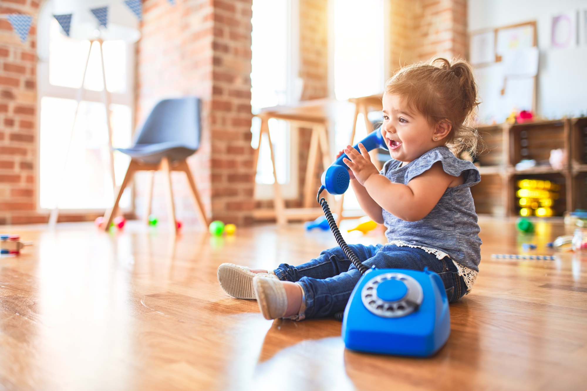 Child holding blue rotary telephone